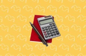 A calculator, a pad and a pen on a yellow background