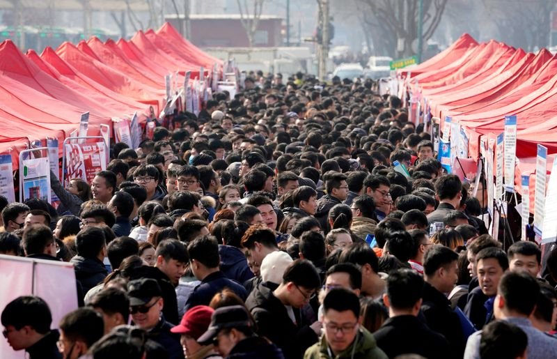 © Reuters. FILE PHOTO: Job seekers crowd a job fair at Liberation Square in Shijiazhuang, Hebei province, China, February 25, 2018. REUTERS/Jason Lee/File Photo